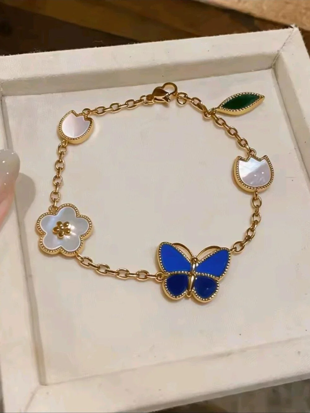 Gold Charm Bracelet with Blue Butterfly and Mother-of-Pearl Accents